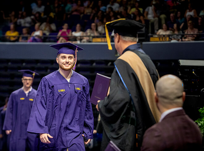 LSU Online graduate walking across stage