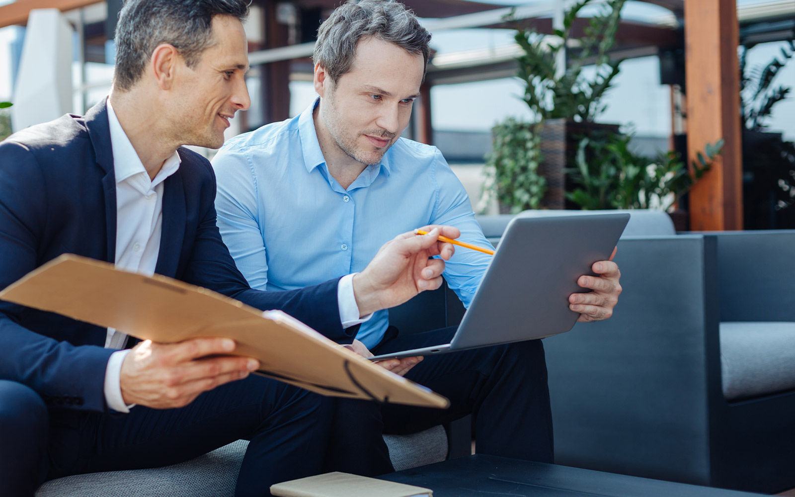 two business men looking at a computer